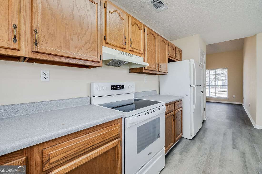 145 John Glenn Drive Rincon, GA 31326 - Photo 14 of 29 a kitchen with stainless steel appliances granite countertop a stove and a refrigerator