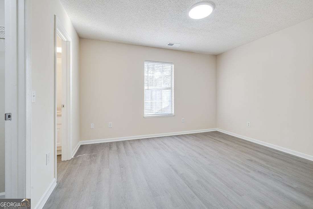 145 John Glenn Drive Rincon, GA 31326 - Photo 16 of 29 an empty room with wooden floor and windows