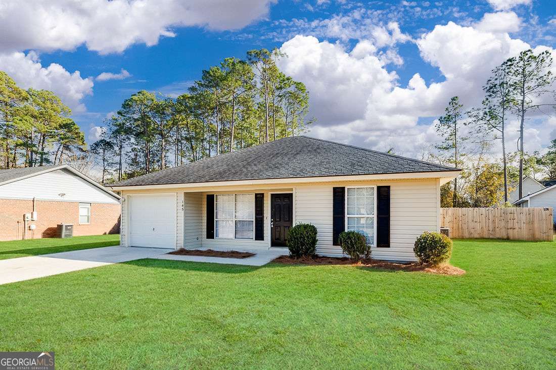 145 John Glenn Drive Rincon, GA 31326 - Photo 2 of 29 a view of a house with a yard and a garden