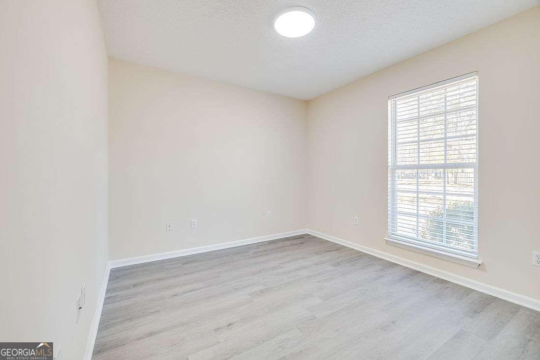145 John Glenn Drive Rincon, GA 31326 - Photo 22 of 29 an empty room with wooden floor and windows