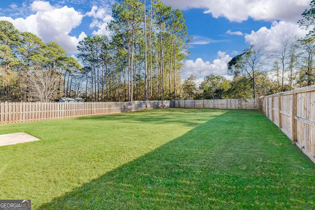 145 John Glenn Drive Rincon, GA 31326 - Photo 27 of 29 a view of a park and trees with wooden fence