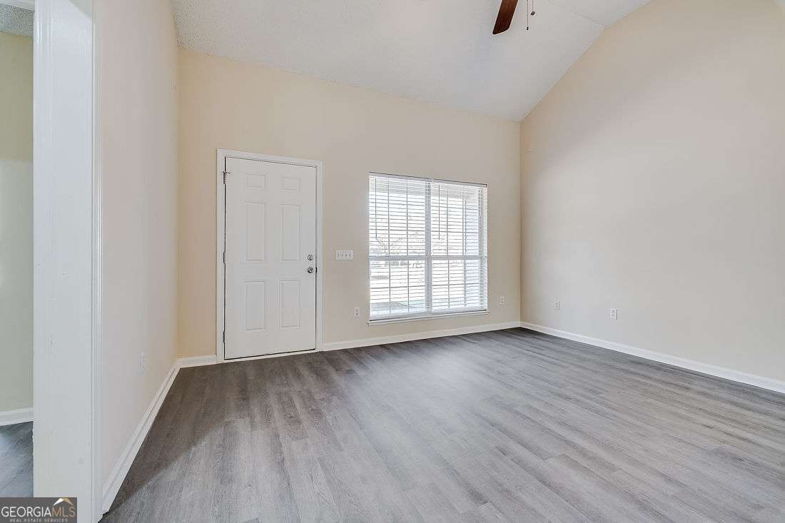 145 John Glenn Drive Rincon, GA 31326 - Photo 6 of 29 an empty room with wooden floor and windows
