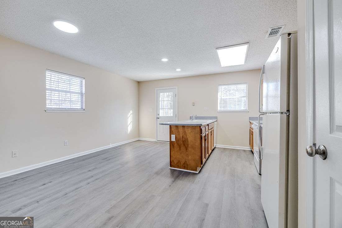 145 John Glenn Drive Rincon, GA 31326 - Photo 7 of 29 wooden floor in an empty room with a window