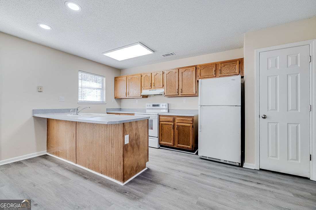 145 John Glenn Drive Rincon, GA 31326 - Photo 8 of 29 a kitchen with a sink a refrigerator and a window