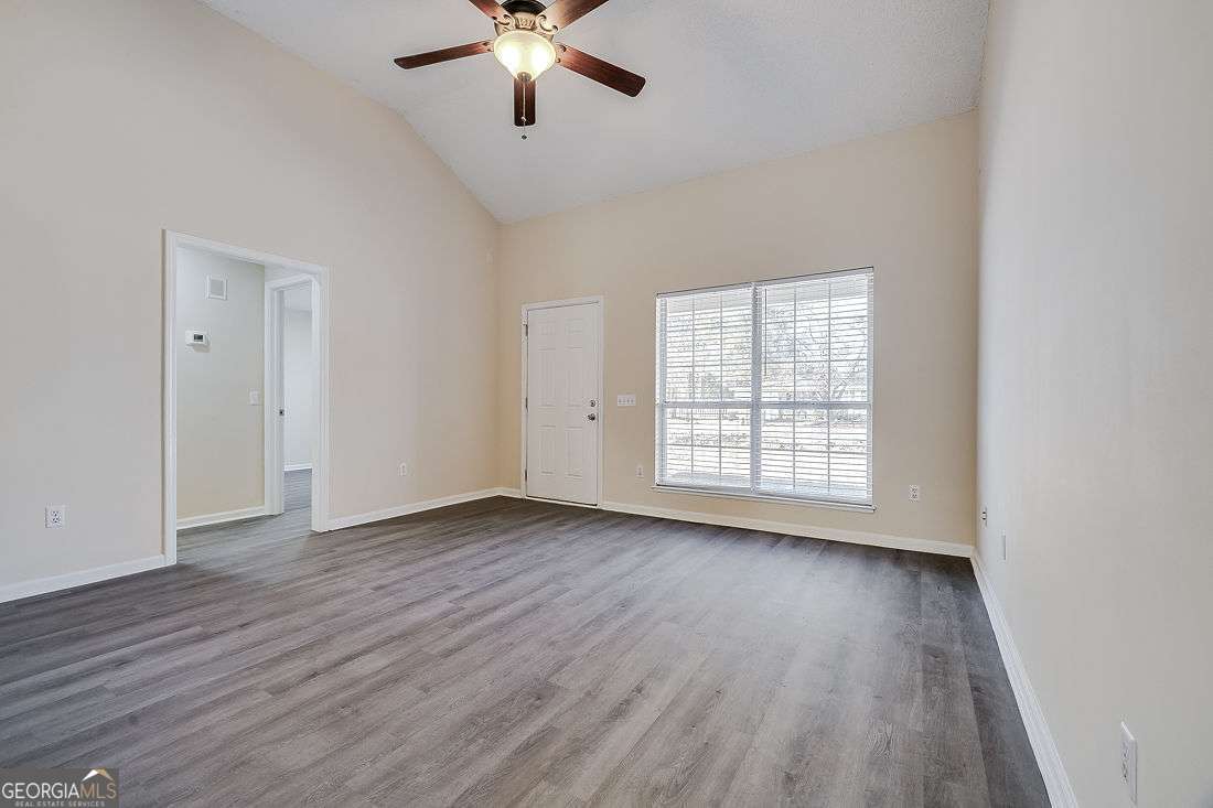 145 John Glenn Drive Rincon, GA 31326 - Photo 9 of 29 a view of an empty room with wooden floor and a window