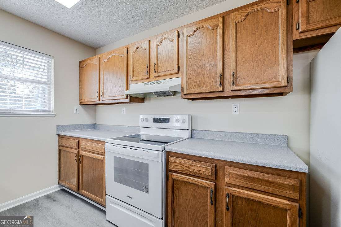 145 John Glenn Drive Rincon, GA 31326 - Photo 10 of 29 a kitchen with stainless steel appliances granite countertop a sink and a microwave
