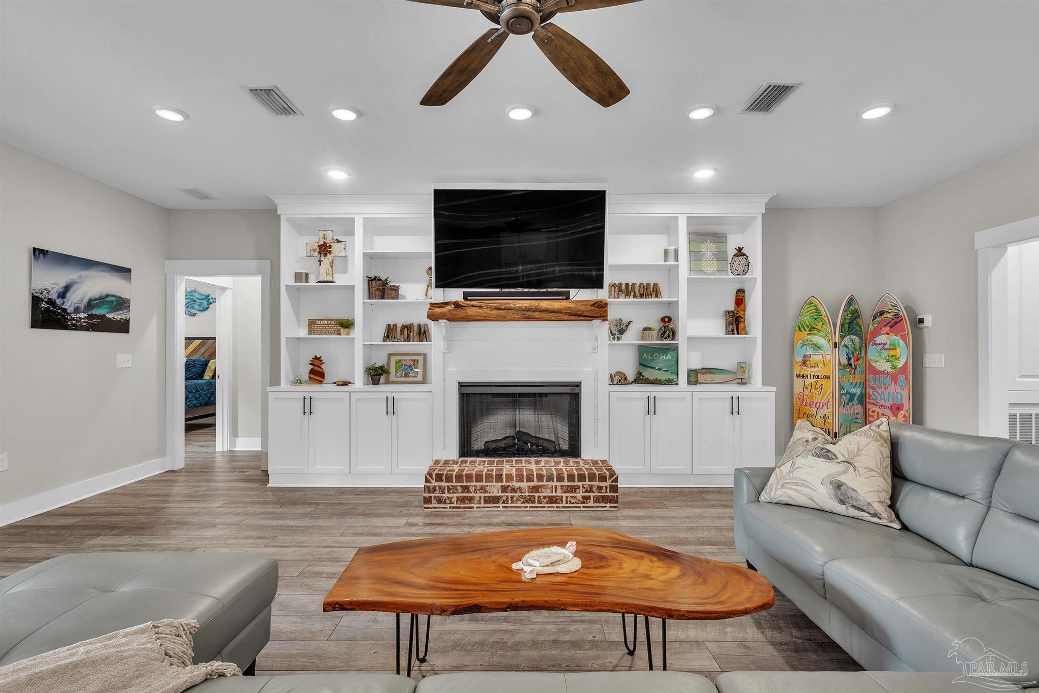 107 Countri Lane Cantonment, FL 32533 - Photo 11 of 35 a living room with furniture a flat screen tv and a fireplace
