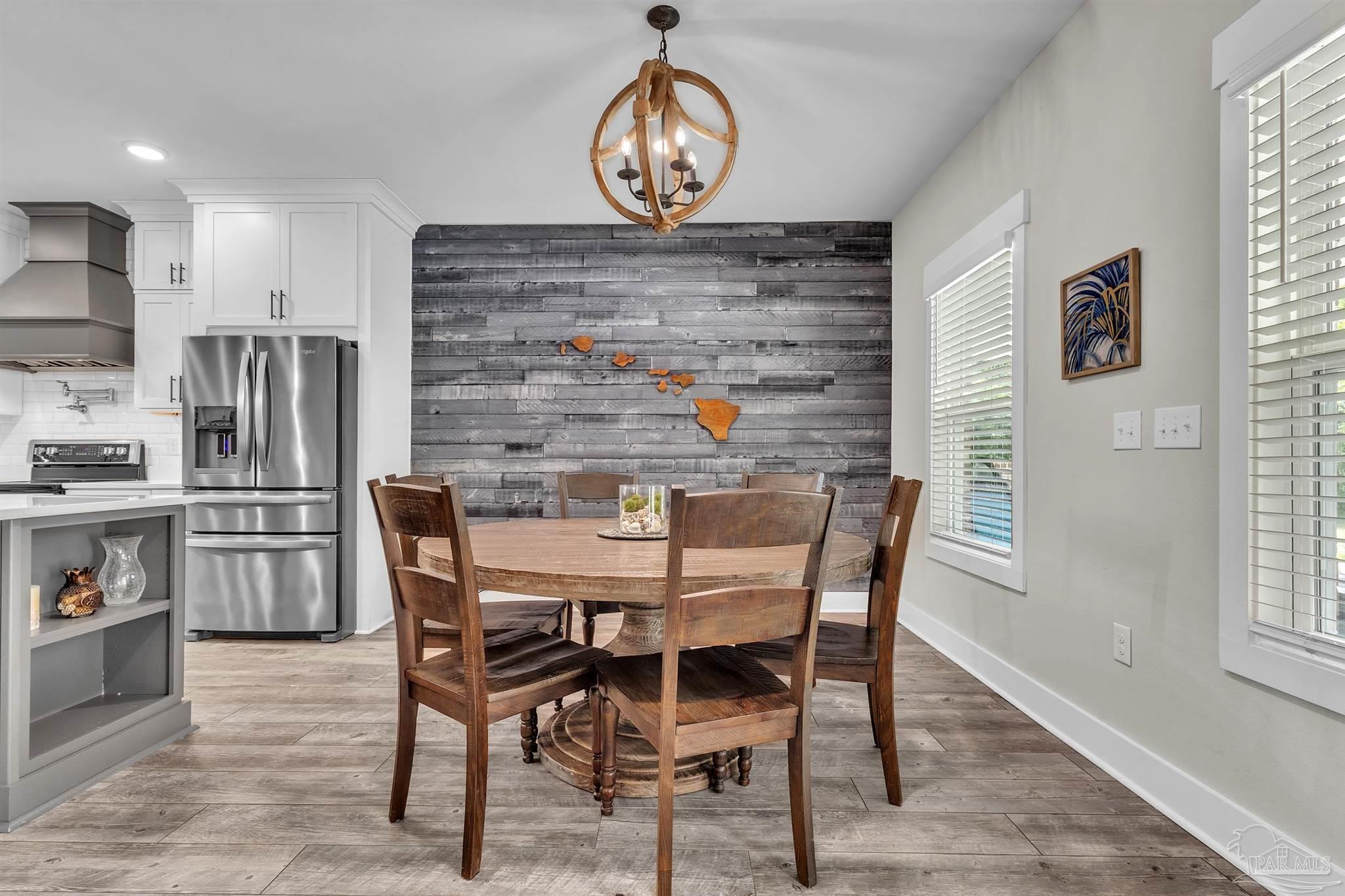 107 Countri Lane Cantonment, FL 32533 - Photo 12 of 35 a view of a dining room with furniture and a chandelier