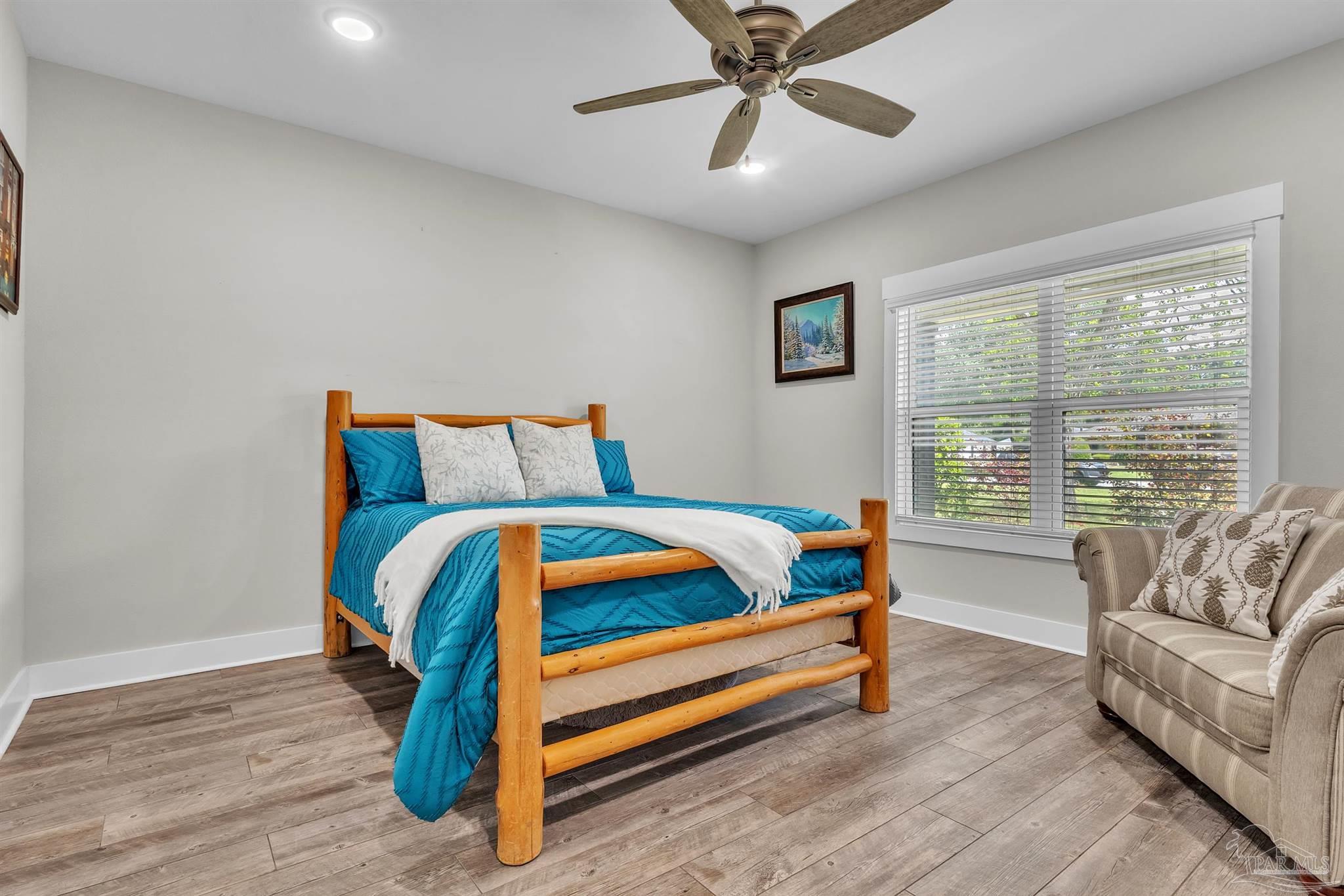 107 Countri Lane Cantonment, FL 32533 - Photo 16 of 35 a bedroom with a bed and a couch