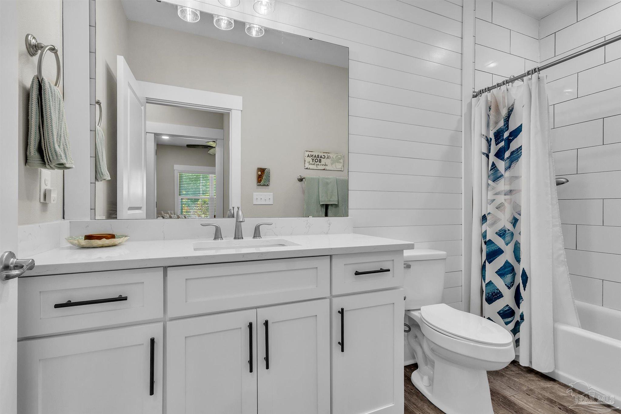107 Countri Lane Cantonment, FL 32533 - Photo 17 of 35 a bathroom with a sink toilet vanity and shower