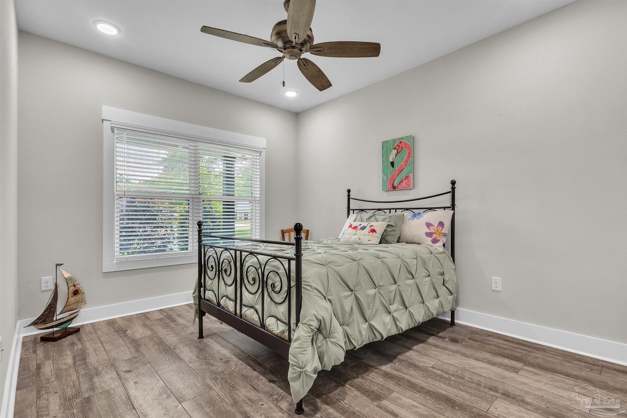 107 Countri Lane Cantonment, FL 32533 - Photo 18 of 35 a bedroom with a bed and a large window