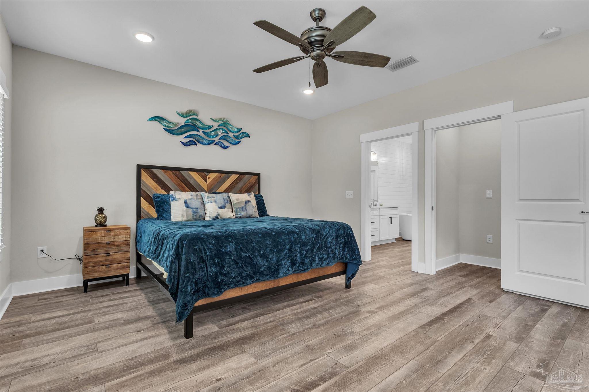 107 Countri Lane Cantonment, FL 32533 - Photo 20 of 35 a bedroom with a bed and a ceiling fan