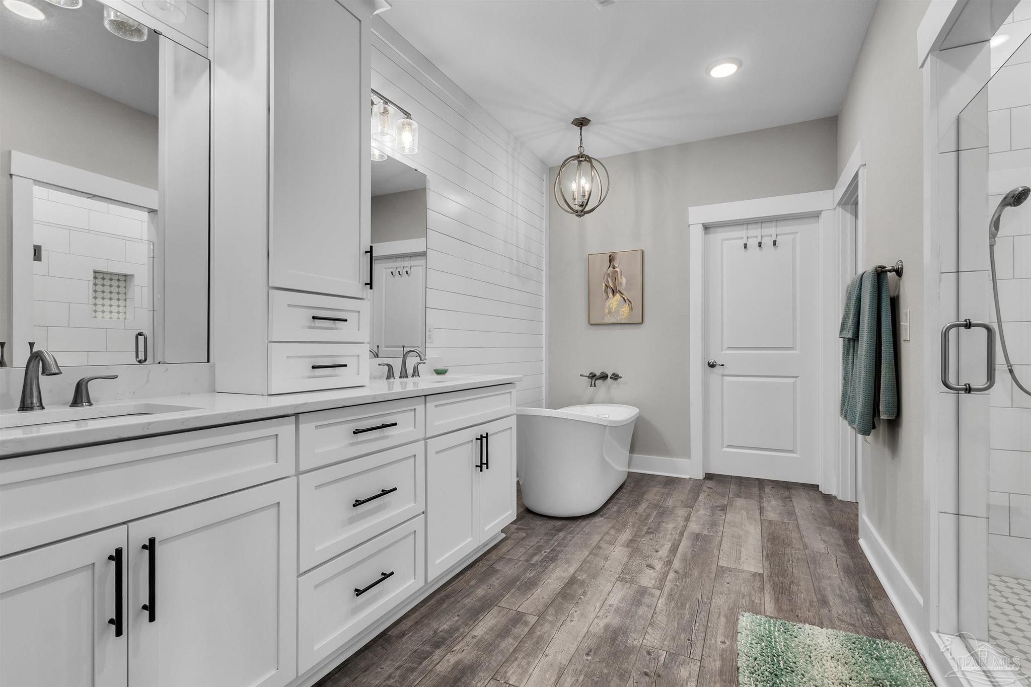 107 Countri Lane Cantonment, FL 32533 - Photo 21 of 35 a spacious bathroom with a double vanity sink a mirror and a bathtub