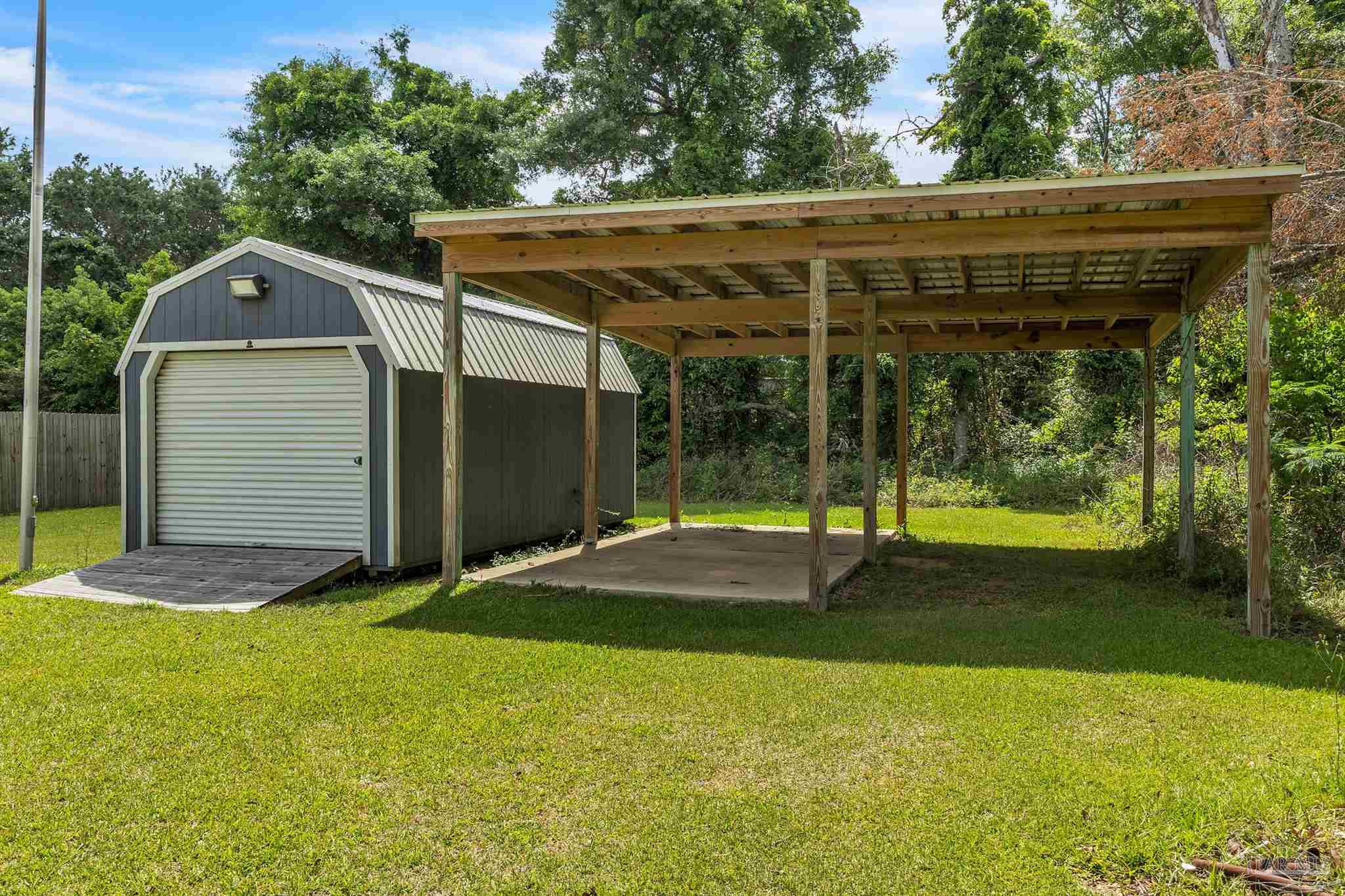 107 Countri Lane Cantonment, FL 32533 - Photo 24 of 35 a backyard of a house with plants and garden