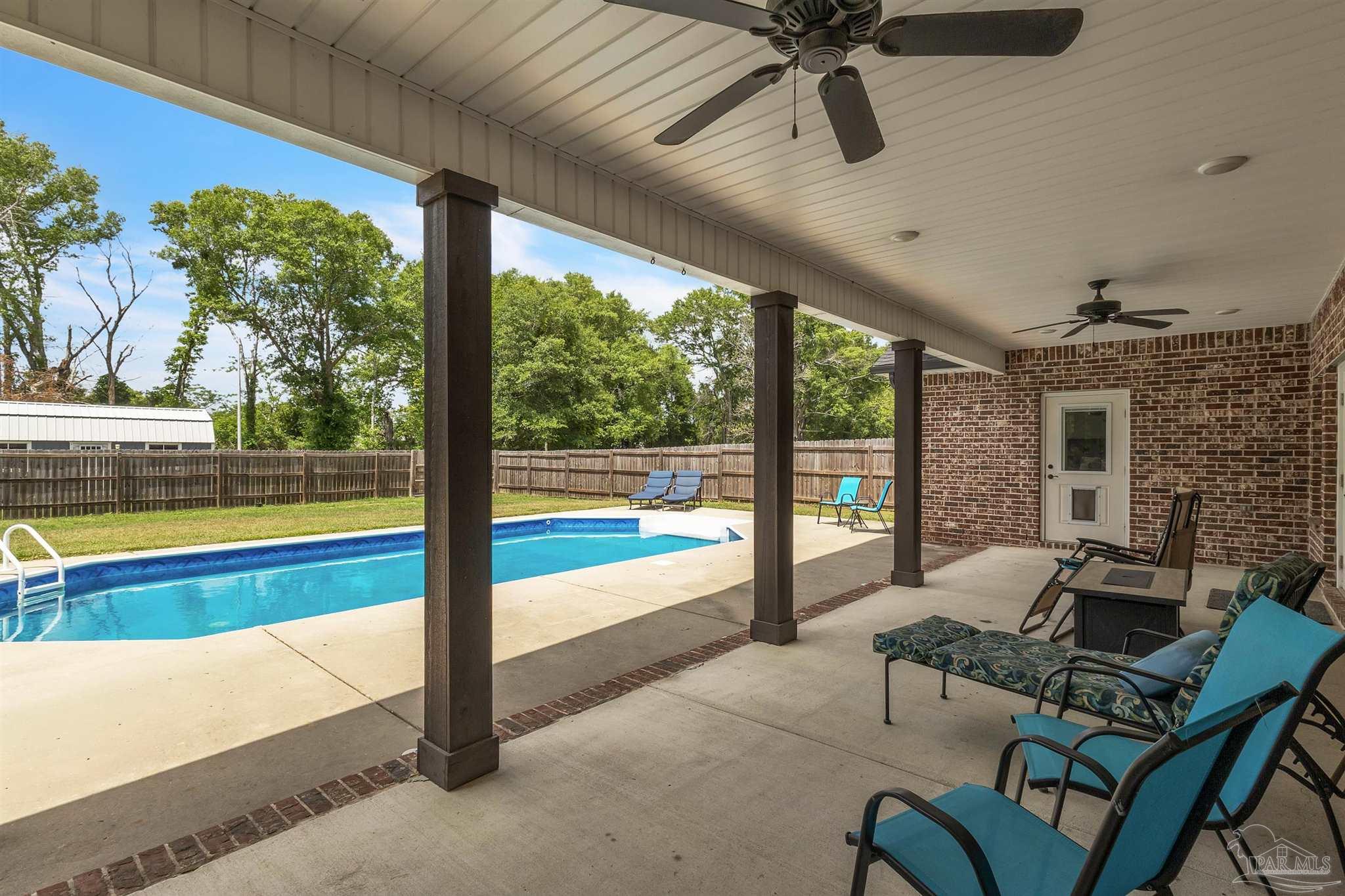 107 Countri Lane Cantonment, FL 32533 - Photo 26 of 35 a living room with furniture and floor to ceiling windows