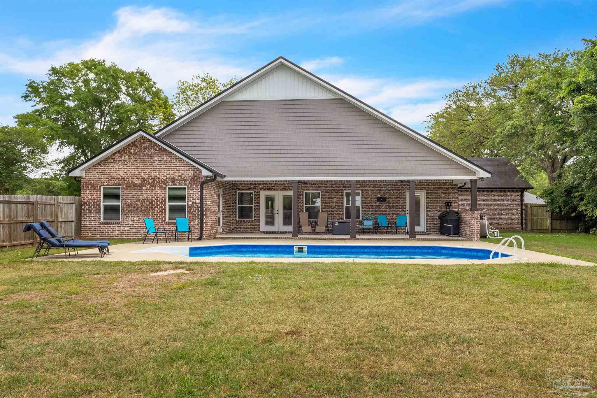 107 Countri Lane Cantonment, FL 32533 - Photo 29 of 35 a view of a house with a yard and sitting area