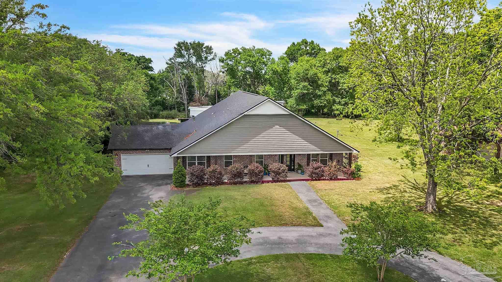 107 Countri Lane Cantonment, FL 32533 - Photo 35 of 35 a house with green field in front of it