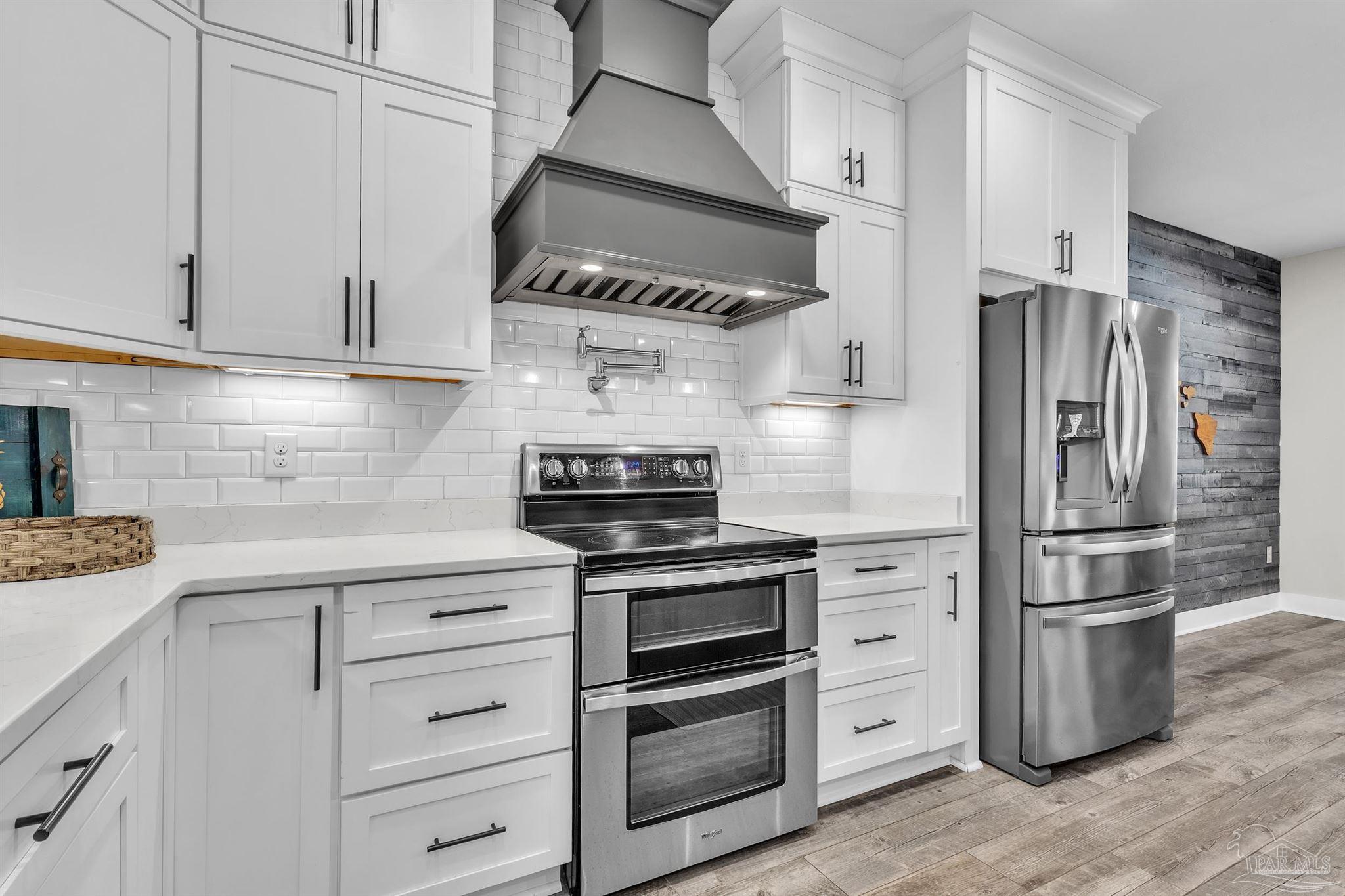 107 Countri Lane Cantonment, FL 32533 - Photo 9 of 35 a kitchen with cabinets and stainless steel appliances
