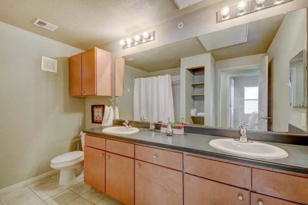 2515 Pearl Street, Unit 605 Austin, TX 78705 - Photo 3 of 15 a bathroom with a sink double vanity and a toilet