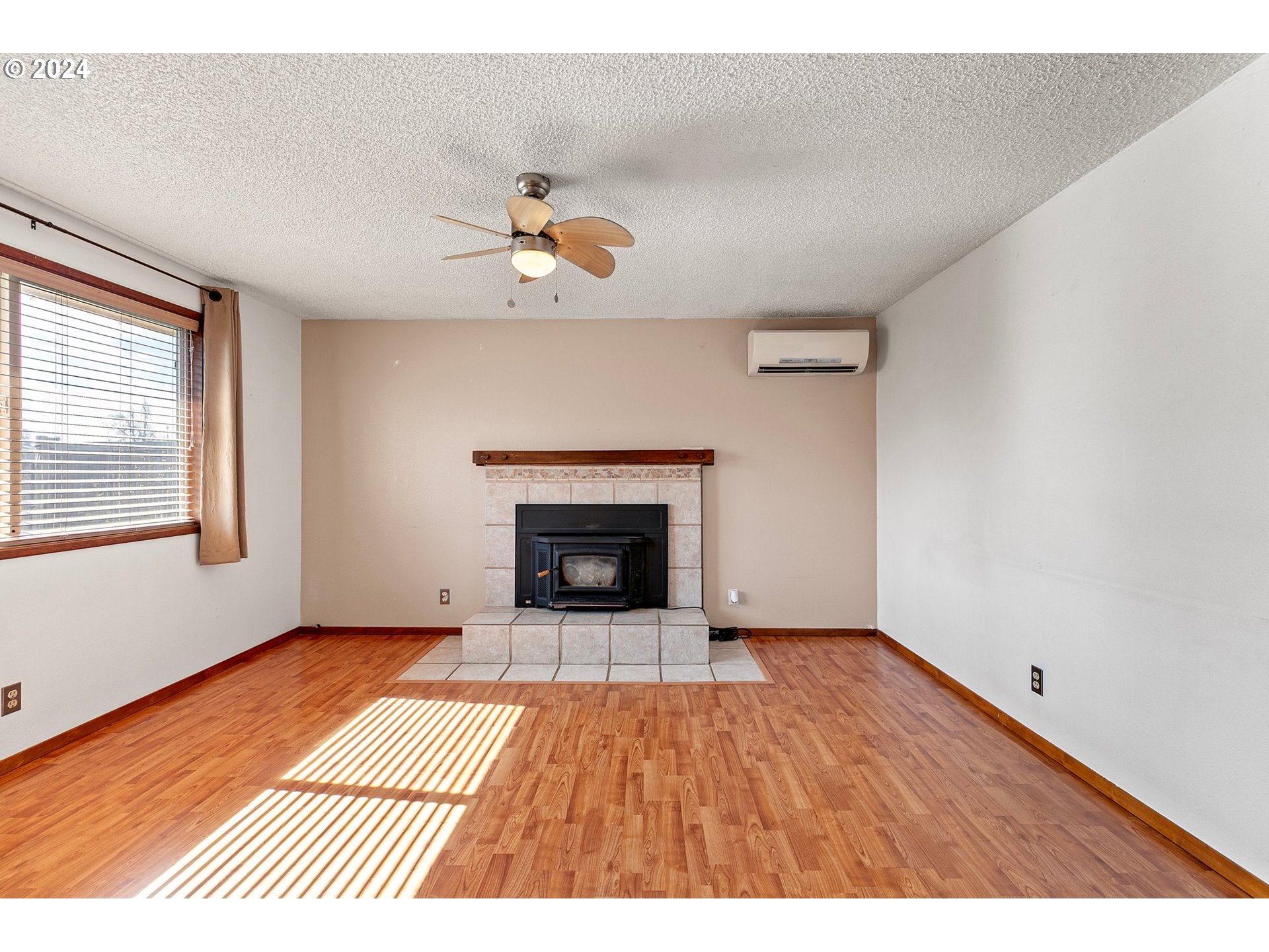 1073 56th Place Springfield, OR 97478 - Photo 3 of 27 a view of an empty room with a window and fireplace