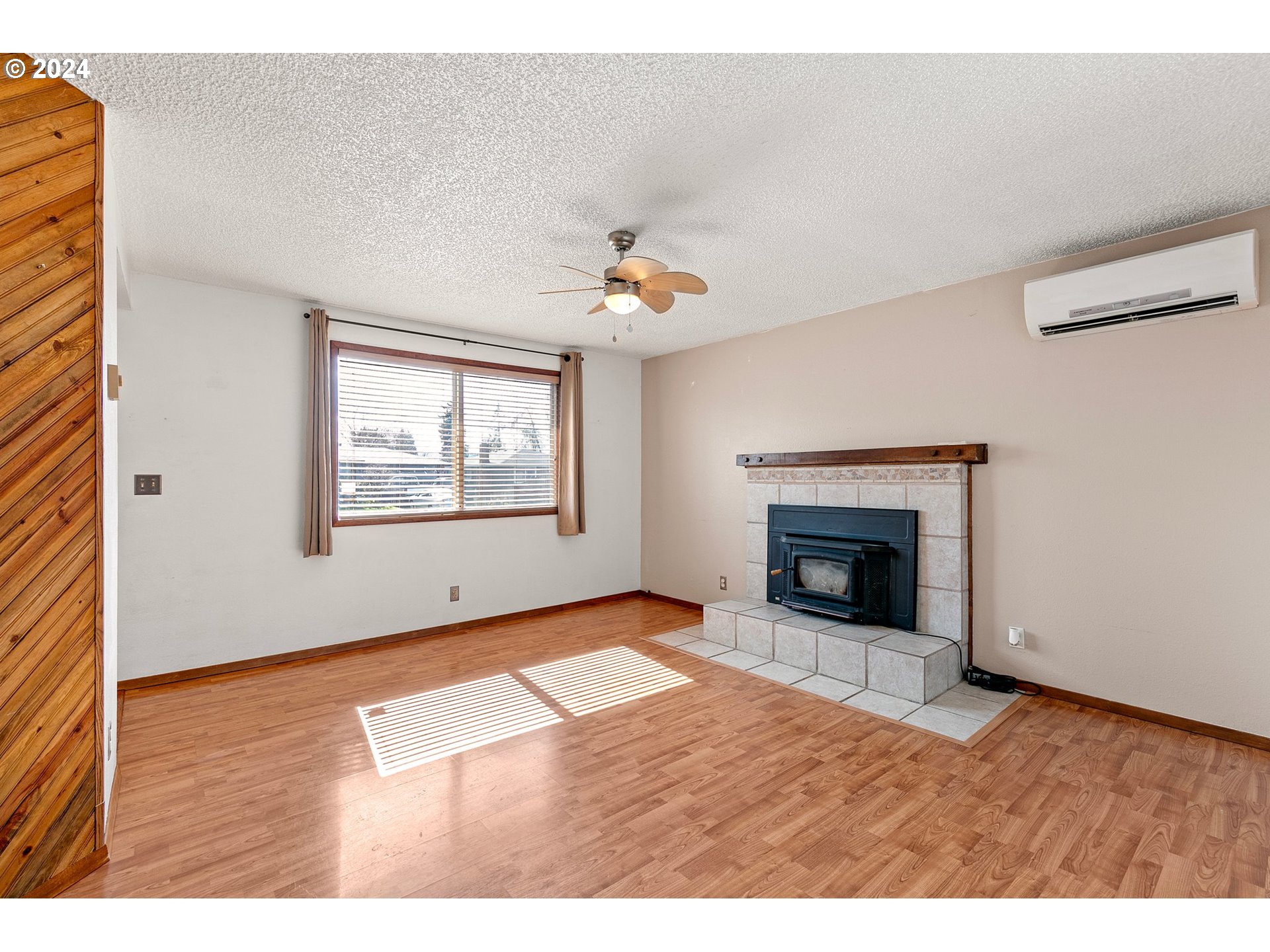 1073 56th Place Springfield, OR 97478 - Photo 4 of 27 a view of an empty room with a fireplace and a window