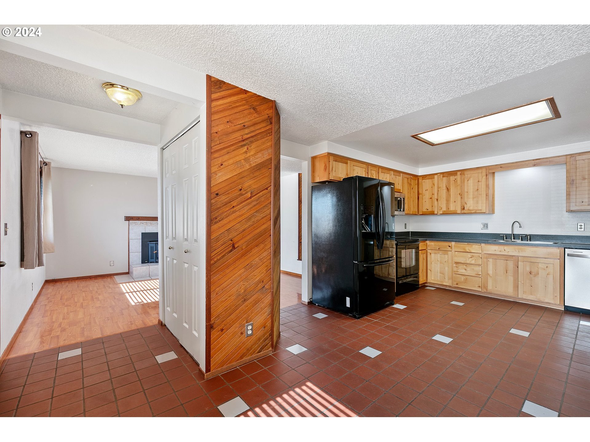 1073 56th Place Springfield, OR 97478 - Photo 5 of 27 a kitchen view with stainless steel appliances kitchen island granite countertop a refrigerator and cabinets