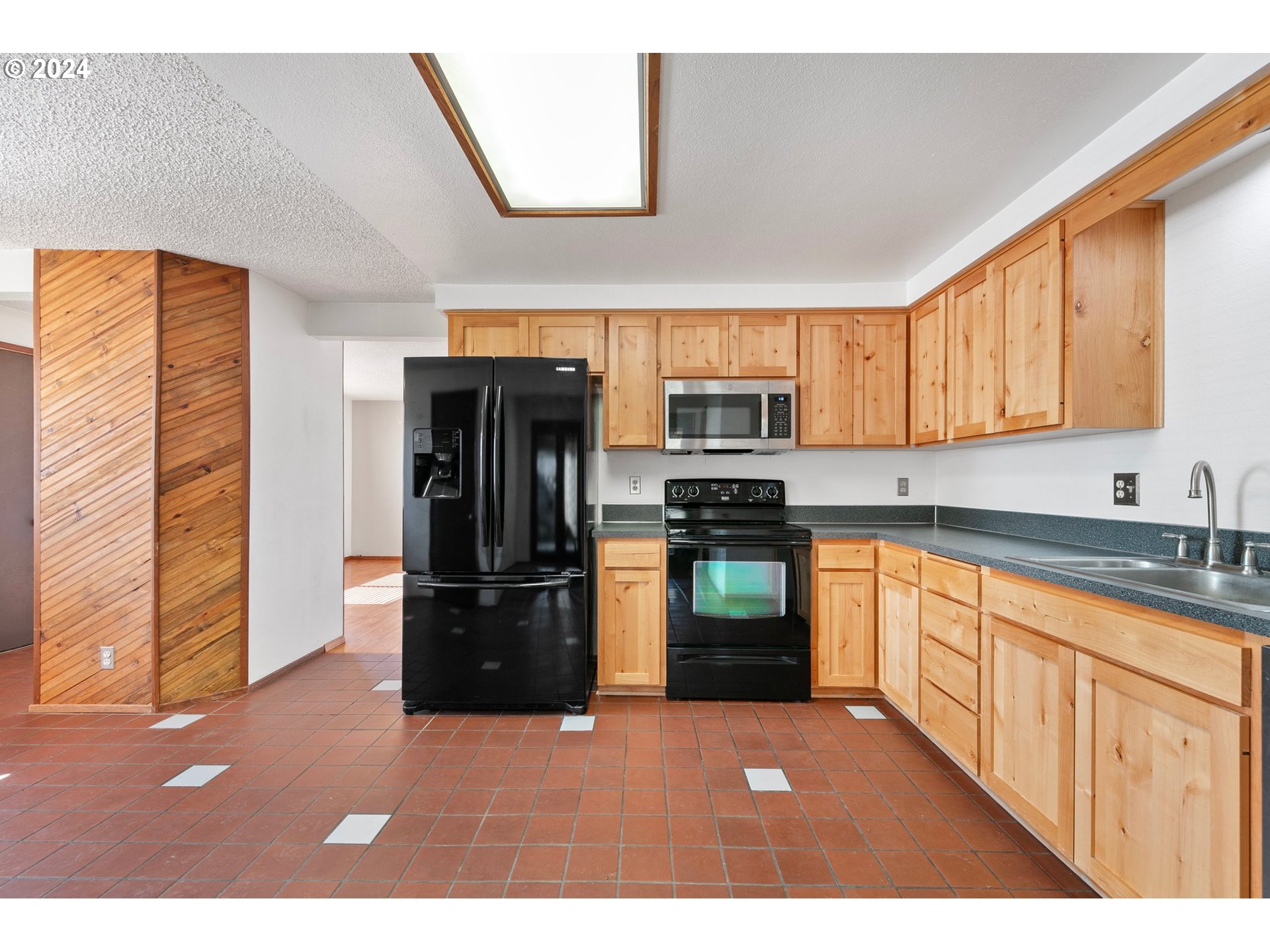 1073 56th Place Springfield, OR 97478 - Photo 6 of 27 a kitchen with stainless steel appliances granite countertop a refrigerator a stove top oven a sink and dishwasher