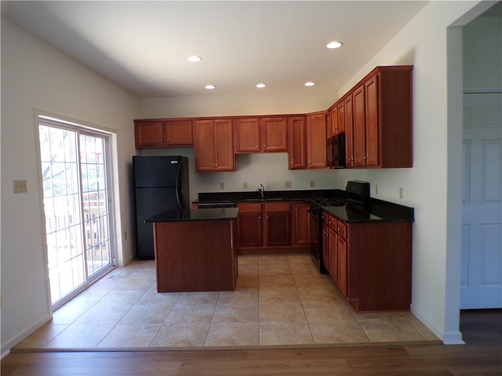 3283 Seip Road Macungie, PA 18062 - Photo 10 of 33 A well-appointed kitchen features rich cabinetry, dark countertops, and a central island, perfect for culinary endeavors.