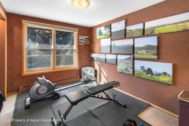 a room with gym equipment and a large window
