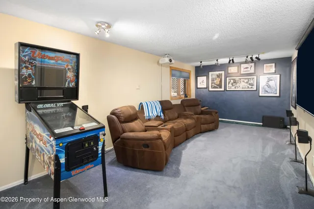 a living room with furniture a flat screen tv and a window