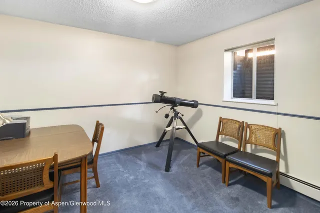 a living room with lots of furniture and a book shelf