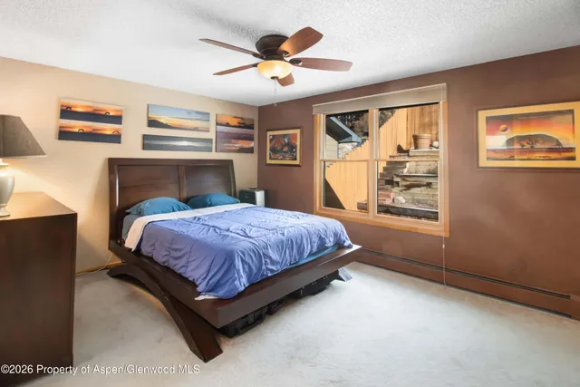 a bed sitting in a room next to a window