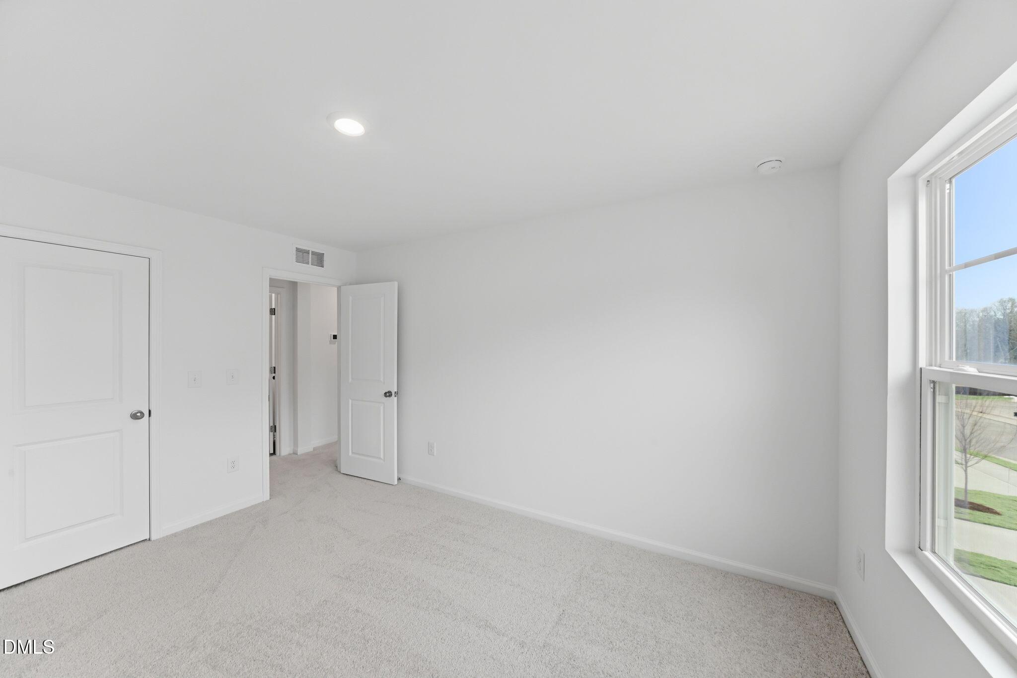 125 Tree Moss Court Rolesville, NC 27571 - Photo 15 of 30 an empty room with windows and closet