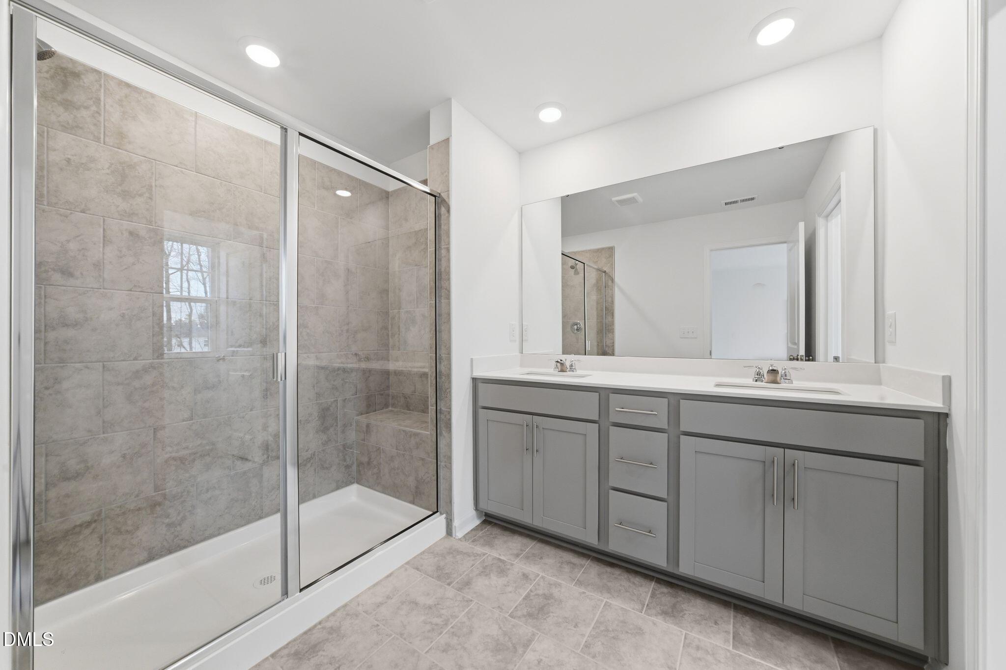125 Tree Moss Court Rolesville, NC 27571 - Photo 25 of 30 a bathroom with double sink and a mirror