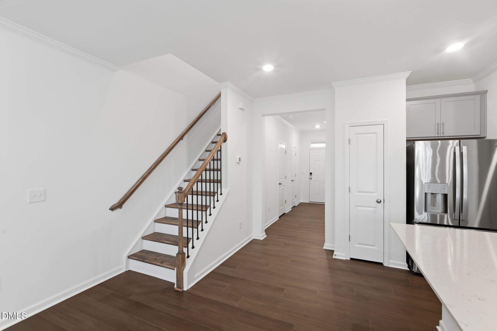 125 Tree Moss Court Rolesville, NC 27571 - Photo 3 of 30 a view of a hallway with wooden floors and stairs