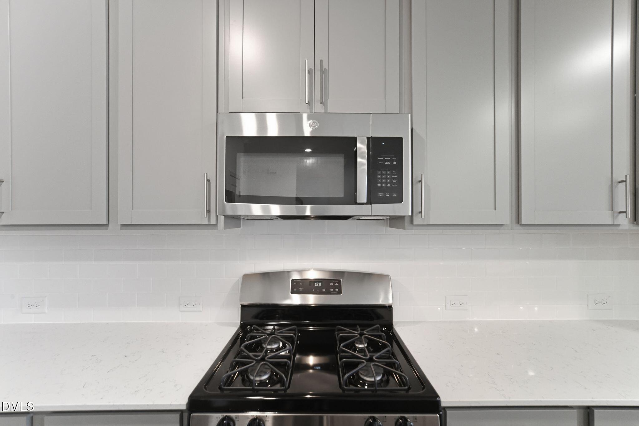 125 Tree Moss Court Rolesville, NC 27571 - Photo 8 of 30 a kitchen with a stove and a microwave