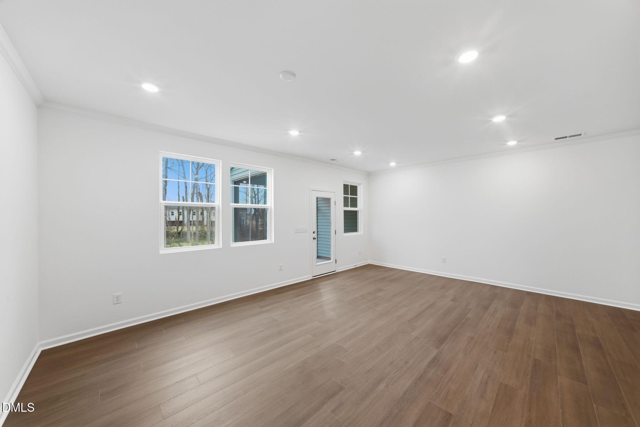 125 Tree Moss Court Rolesville, NC 27571 - Photo 10 of 30 an empty room with wooden floor and windows