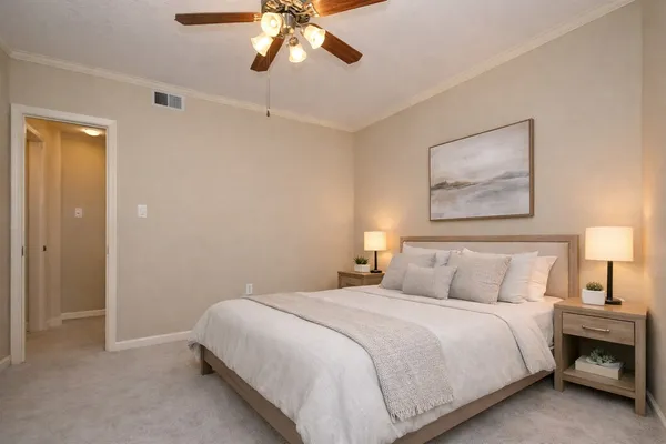 a bedroom with a bed and a chandelier