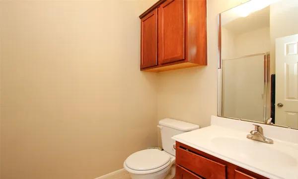 a bathroom with a sink a toilet and mirror