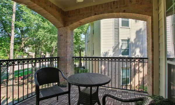 a view of a balcony with furniture