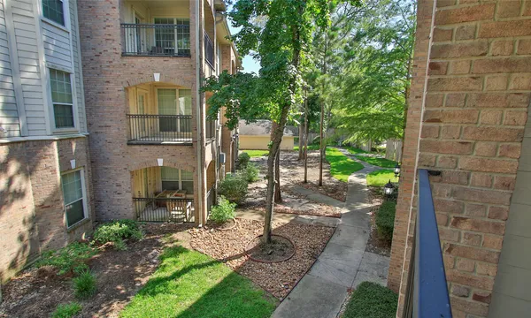 a view of a brick house with a yard