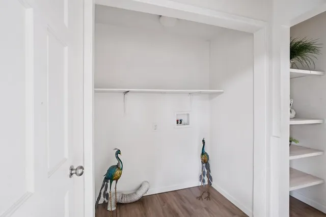 a hallway with table and a closet