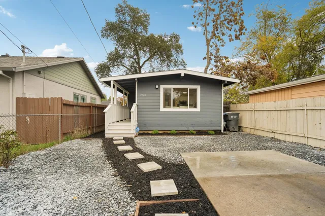 an aerial view of a house with a yard and lake view