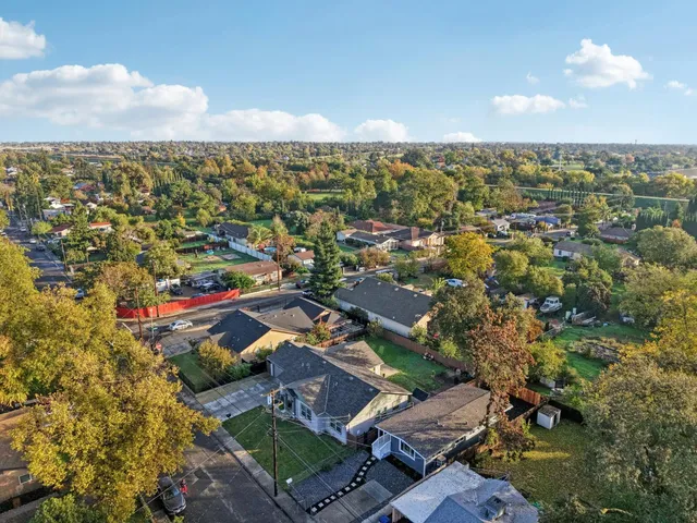 an aerial view of residential houses with outdoor space