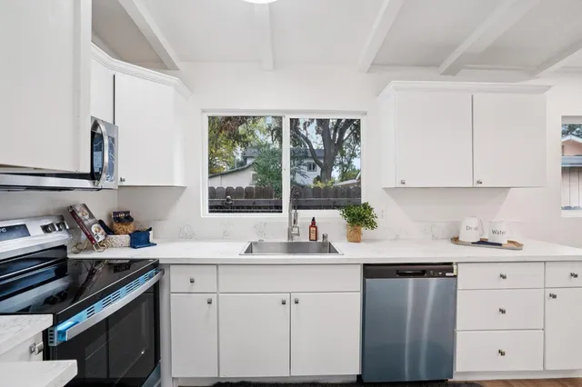 a kitchen with a sink stove and window