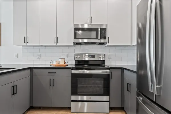 a kitchen with stainless steel appliances granite countertop a stove and a refrigerator