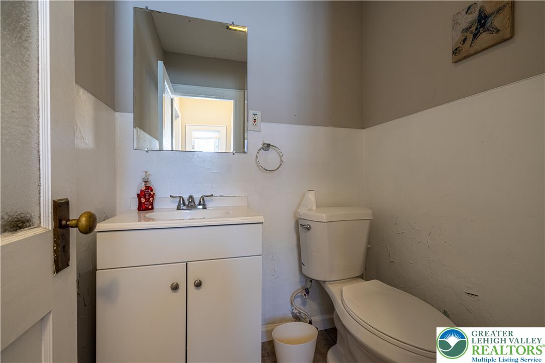 118 South 3rd Street Bangor, PA 18013 - Photo 12 of 33 This functional bathroom features a classic vanity and toilet, ready for personal touches.