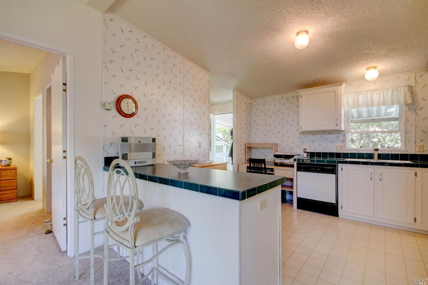 72 Yosemite Road, Unit 72 San Rafael, CA 94903 - Photo 1 of 1 a kitchen with granite countertop a sink cabinets and window