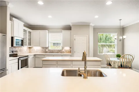 a kitchen with stainless steel appliances granite countertop a stove and a sink