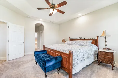 a bedroom with a bed and a chandelier